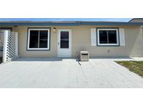 Charming single-story home with a welcoming front entrance and neutral-colored exterior with a concrete patio at 254 Winter Ridge Blvd # 254, Winter Haven, FL 33881