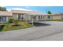 Inviting single-story home featuring a convenient carport and well-maintained landscaping at 299 Winter Ridge Blvd # 299, Winter Haven, FL 33881
