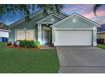 Charming single-story home with a well-maintained lawn, tidy landscaping, and two-car garage at 436 China Berry Cir, Davenport, FL 33837