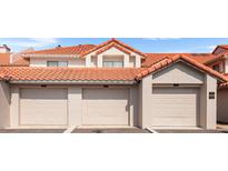 Three-car garage exterior showing numbered units with terra cotta tile roof at 703 Magnolia Pl # 703, Winter Haven, FL 33884