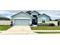 Charming single-story home featuring a two-car garage, well-manicured lawn, and inviting front entrance at 832 Vienna Dr, Winter Haven, FL 33884