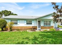 Charming single-story home featuring a well-maintained lawn and colorful landscaping at 109 Dakota Ave, St Cloud, FL 34769