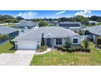 Charming single-story home with well-maintained landscaping, stone accents, and a two-car garage at 114 Belmont Dr, Winter Haven, FL 33884