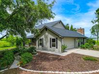 Charming home featuring a well-maintained yard, mature trees, and an attached garage, providing both beauty and convenience at 1256 Center St, Lake Wales, FL 33859