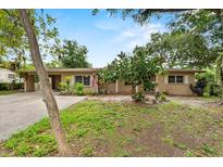 Charming single-story home featuring a covered parking area and mature landscaping at 1810 Roanoke Ave, Lakeland, FL 33803