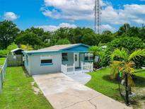 Charming single-story home with a well-manicured lawn, inviting curb appeal, and blue accents at 2480 Avenue E Sw, Winter Haven, FL 33880