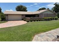 Well-maintained single-story home with a lush green lawn and paved driveway at 381 Troon Ct, Winter Haven, FL 33884