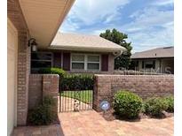 Charming single-story home with brick paved walkway and gated courtyard at 381 Troon Ct, Winter Haven, FL 33884