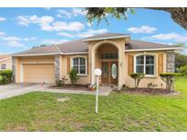 Charming single-story home featuring a well-manicured lawn and inviting arched entryway at 4338 Dinner Lake Blvd, Lake Wales, FL 33859