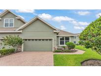 Charming townhouse with a brick driveway, a two-car garage, and well-maintained landscaping at 6528 Sedgeford Dr, Lakeland, FL 33811