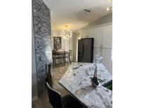 Bright kitchen with granite countertops, stainless steel appliances, and a decorative backsplash at 7929 Ashley Pointe Dr, Lakeland, FL 33810