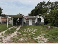 Modest single Gathering home featuring a carport and front lawn, in need of some TLC at 803 26Th Nw St, Winter Haven, FL 33881