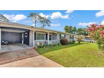Charming single story home with brick accents, carport, well-maintained lawn, and inviting curb appeal at 1019 Milner E Dr, Lakeland, FL 33810