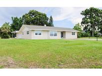 Charming single-story home featuring a well-maintained lawn and neutral-colored exterior at 1476 Avenue F Ne, Winter Haven, FL 33881