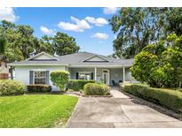 Charming single-story home featuring lush landscaping, a well-manicured lawn and a welcoming front entrance at 15 Edwards Shrs, Haines City, FL 33844