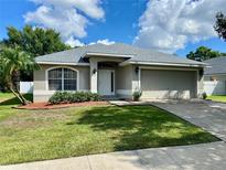 Charming one-story home with a well-maintained lawn, fresh landscaping, and a neutral color scheme at 1790 Turtle Rock Dr, Lakeland, FL 33803