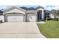 Charming single-story home featuring a well-maintained lawn, a two-car garage, and a welcoming entrance at 185 St Thomas Dr, Mulberry, FL 33860