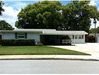Charming single story home with a well-maintained lawn and covered parking at 2021 Oliver Pl, Winter Haven, FL 33881
