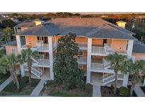 Three-story condo with white railings and palm trees at 209 Andros Ave # 15301, Davenport, FL 33897