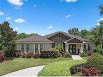 Beautiful single-story home with stone facade and well-manicured lawn offers great curb appeal at 2977 Sequoyah Dr, Haines City, FL 33844