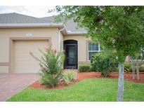 Charming single-story home featuring manicured landscaping and an attached two-car garage at 3023 Caneel, Winter Haven, FL 33884