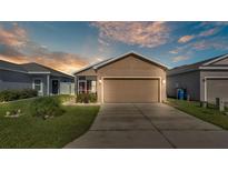 Charming single-Gathering home featuring a well-manicured lawn and an attached two-car garage at 3173 Whispering Trails Ave, Winter Haven, FL 33884