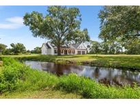 Charming home with a serene water feature and a lush green landscape in a tranquil setting at 5820 E Johnson Ave, Haines City, FL 33844
