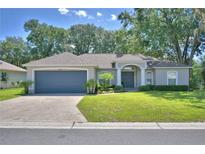 Charming single-story home with a well-manicured lawn and attached two-car garage at 6028 Hillside Heights Dr, Lakeland, FL 33812