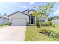 Charming single Gathering home featuring a well maintained lawn and two car garage at 6300 Dolostone Dr, Lakeland, FL 33811
