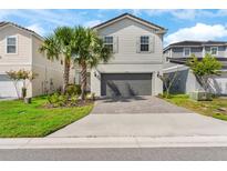 Charming two-story home with a brick paved driveway and well-maintained landscaping at 7247 Oakmoss Loop, Davenport, FL 33837