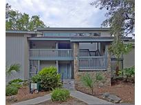 Condo exterior shows a two-story facade with stone accents and tropical landscaping at 816 Pinewood Ct # 3126, Haines City, FL 33844