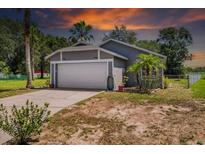Charming single-story home with a two-car garage and lush landscaping at 1100 Lowry Ave # 63, Lakeland, FL 33801