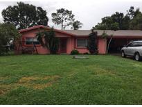 Charming single-story home featuring lush green lawn and mature trees for shade and curb appeal at 1811 5Th Se St, Winter Haven, FL 33880