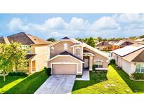 Charming two-story home featuring well-maintained landscaping and an attached two-car garage at 2169 Rose Blvd, Winter Haven, FL 33881