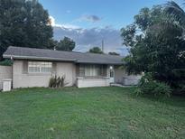 Charming single-story brick home featuring a well-maintained lawn and mature landscaping at 2800 Sunset Nw Dr, Winter Haven, FL 33881