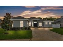 Charming single-story home features a well-manicured lawn, fresh landscaping, and neutral stucco exterior at 308 Kissengen Park Dr, Bartow, FL 33830