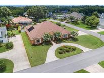 Stunning aerial view of a home with mature landscaping and a circular driveway at 328 Hamilton Shores Ne Dr, Winter Haven, FL 33881