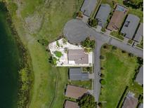 Beautiful aerial view of lakefront property with manicured landscaping and mature trees at 452 Lake Suzanne Dr, Lake Wales, FL 33859