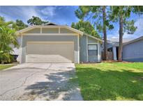 Charming single-Gathering home featuring an attached two-car garage and a well-maintained lawn at 658 Lake Dexter Cir, Winter Haven, FL 33884