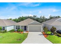 Charming single-story home with a well-manicured lawn and a two-car garage at 1274 Pintail Pl, Lakeland, FL 33813