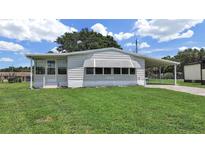 Charming single-story home with a well-manicured lawn and covered parking at 1548 Longbow Dr, Lakeland, FL 33810
