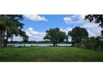 Expansive backyard with large mature trees and gorgeous lake view at 1736 3Rd Ne St, Winter Haven, FL 33881