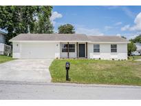 Charming, renovated one-story home featuring a new roof and white painted brick exterior with tidy front yard at 4921 Sharon Ave, Lakeland, FL 33812