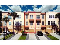 Charming multi-story townhome featuring a private garage, neutral exterior, and well-maintained landscaping at 5002 Tideview Cir # 3, Orlando, FL 32819