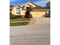 Attractive one-story home with a two-car garage and well-manicured lawn at 1159 Greenley Ave, Groveland, FL 34736