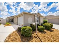 Single-story home with attached garage and well-maintained landscaping at 2605 Seneca Ave, The Villages, FL 32162