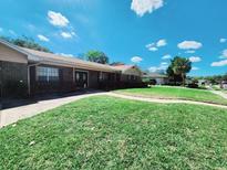 Charming brick home featuring a well-maintained lawn and inviting front entrance at 413 Sandy Hill Dr, Longwood, FL 32779