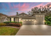 Attractive single-story home with two-car garage and landscaped front yard at 7838 Sloewood Dr, Leesburg, FL 34748