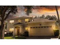 Two-story house with a large garage and landscaped front yard at 4055 Beacon Ridge Way, Clermont, FL 34711