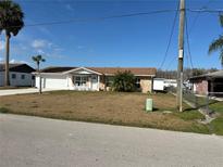 Charming single-story home with a well-manicured lawn and attached garage at 1618 Juno Trail, Astor, FL 32102